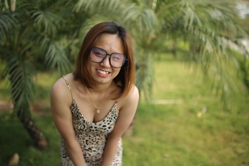 Image 2/21: Eyeglasses and leopard dress frame this sweet Asian babe outdoors