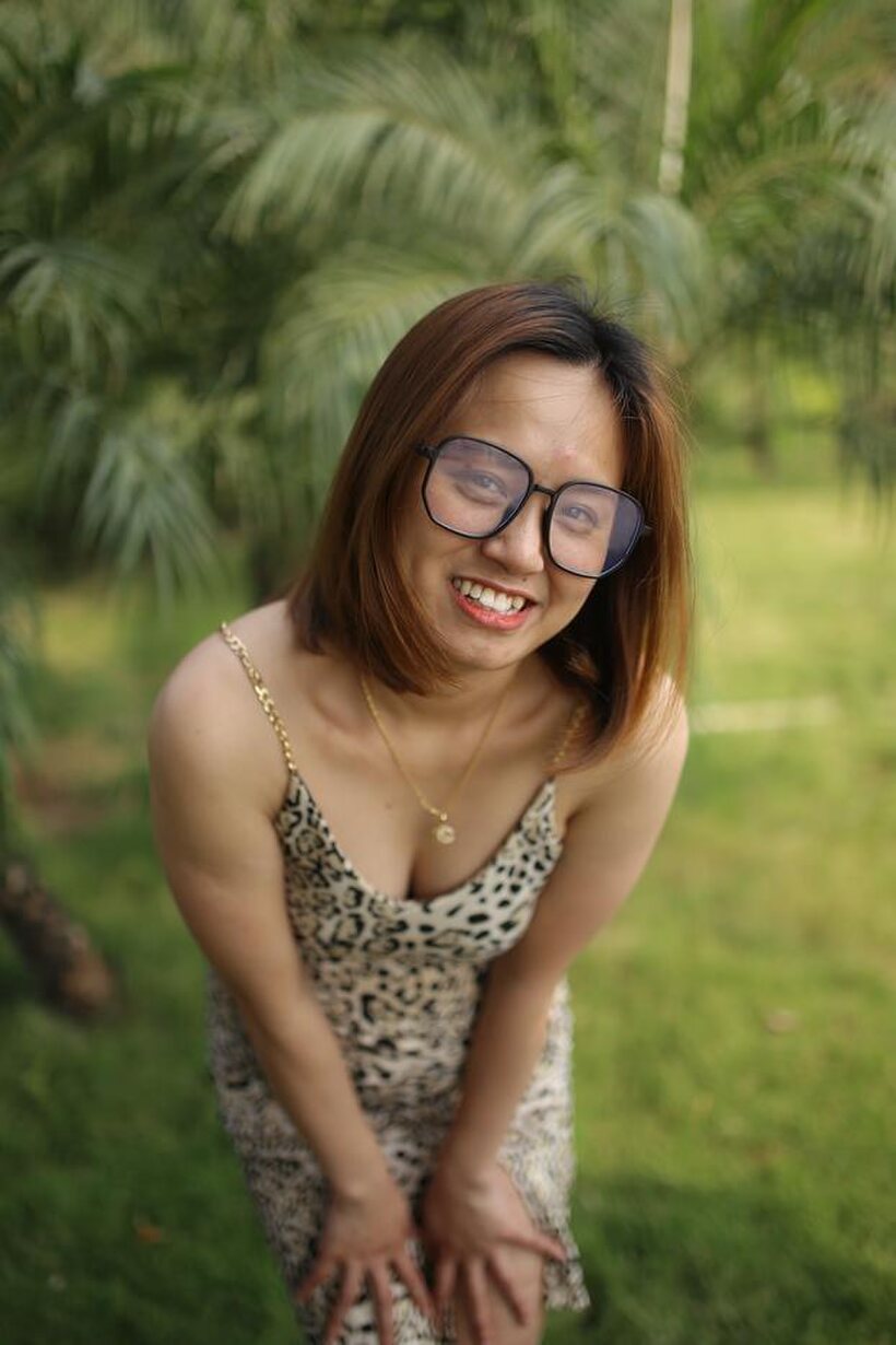 Photo 4 — Eyeglasses and leopard dress frame this sweet Asian babe outdoors