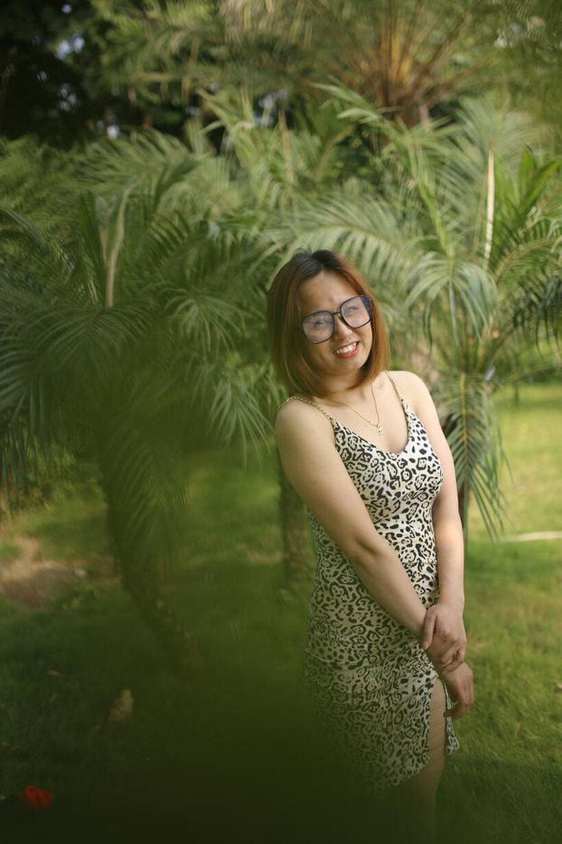 Eyeglasses and leopard dress frame this sweet Asian babe outdoors (shot 5)