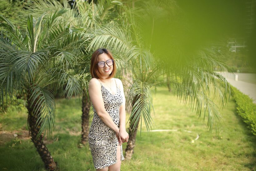 Image 8/21: Eyeglasses and leopard dress frame this sweet Asian babe outdoors