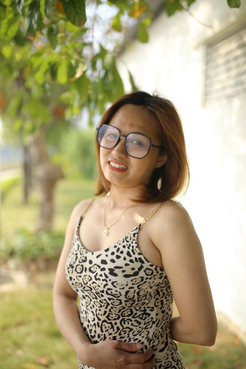 Image 16/21: Eyeglasses and leopard dress frame this sweet Asian babe outdoors