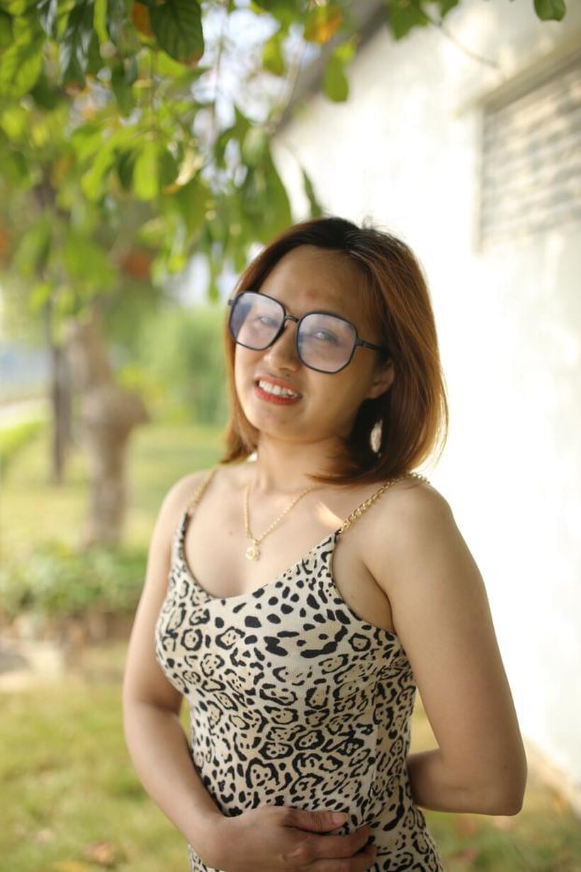 Image 17/21: Eyeglasses and leopard dress frame this sweet Asian babe outdoors