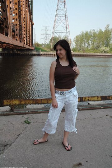 Barefoot by the water, young amateur shows off her pussy and tits