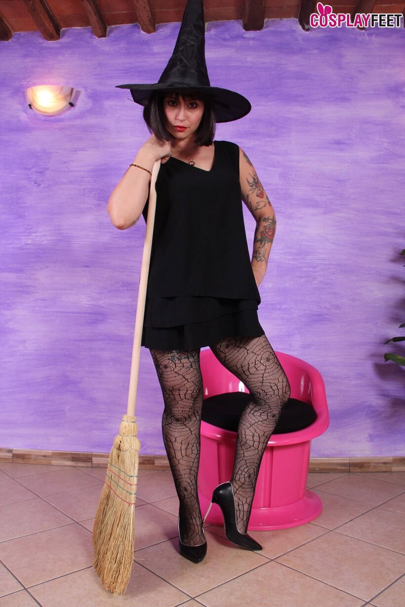 Image 2/10: Tattooed brunette Ammalia poses in Halloween pantyhose and shows her feet
