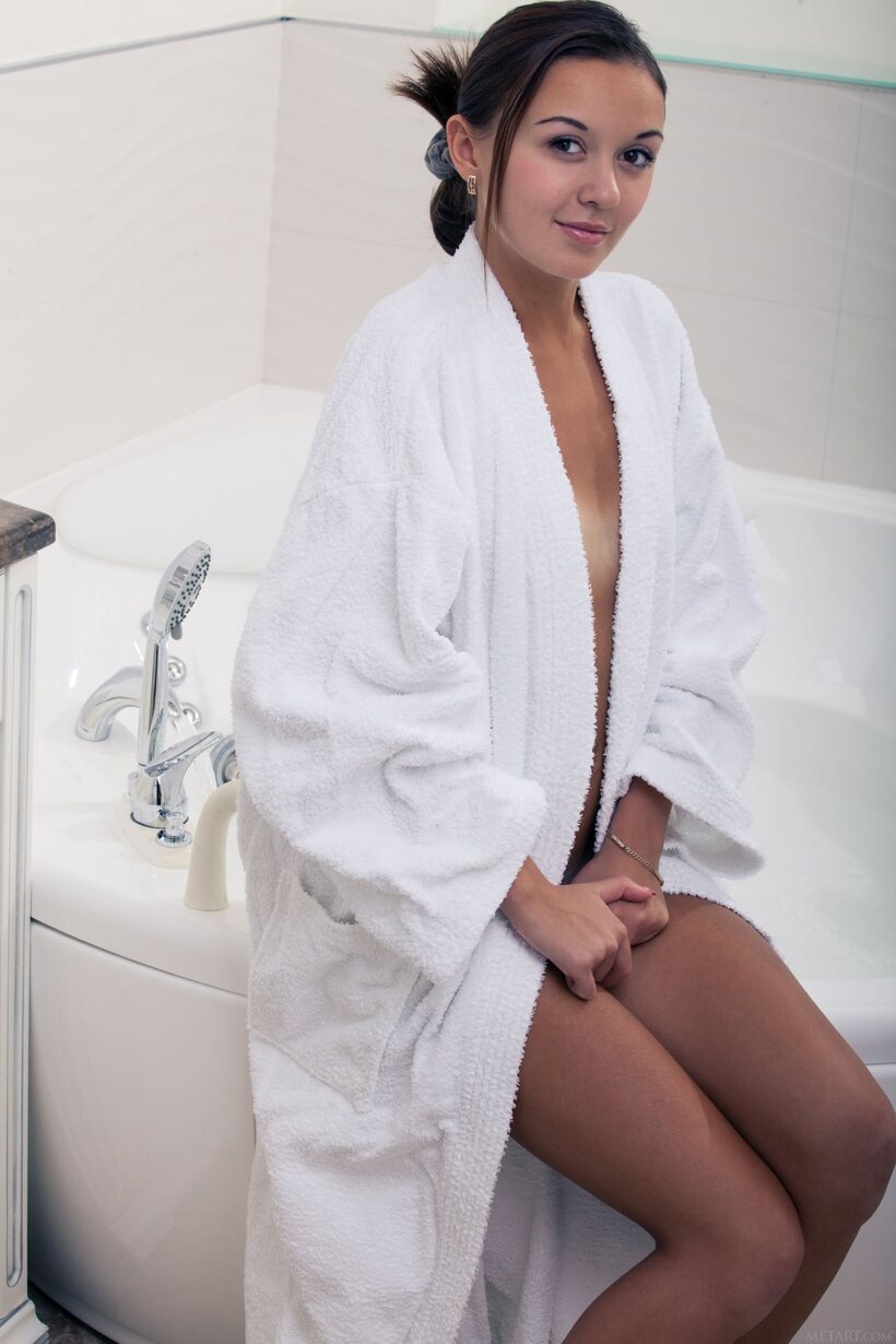 Photo 2 — Veselin peels off her bathrobe before slipping into the bath