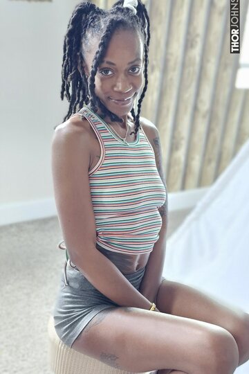 Tongue out, cute ebony girl slips her big booty from a thong
