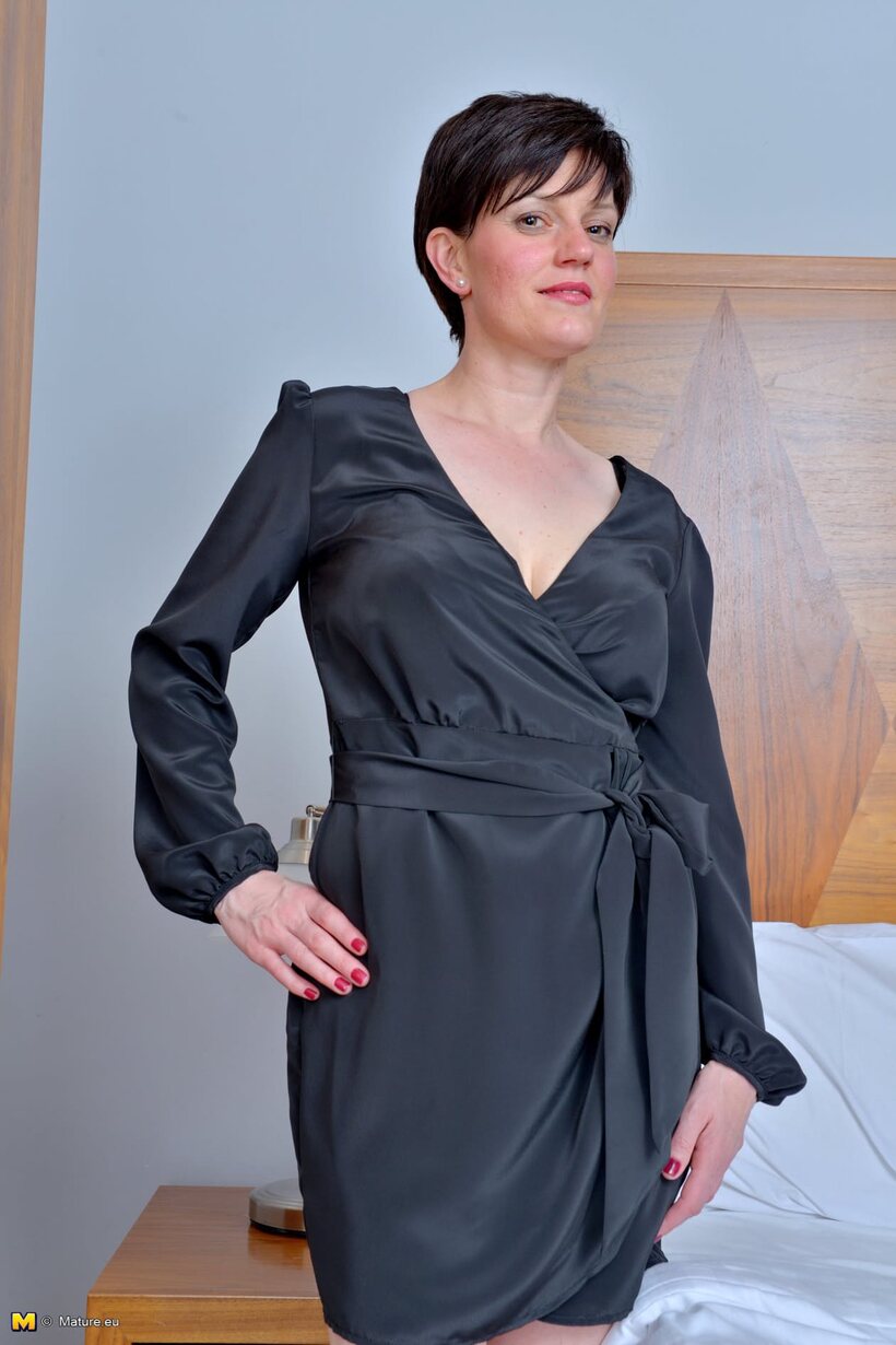 Mature lady sheds her black robe and lingerie, then poses nude (shot 1)
