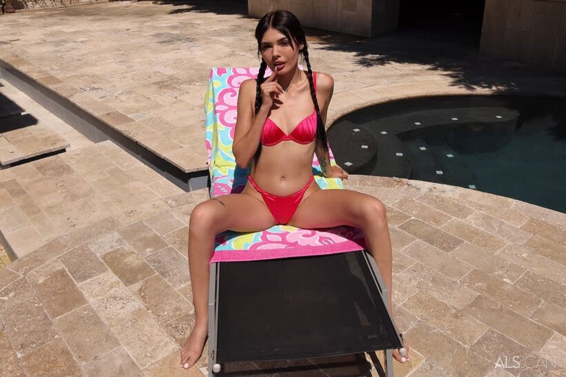 Photo 1 — Luna Bunny drops her bikini and fingers her shaved pussy on a lounger