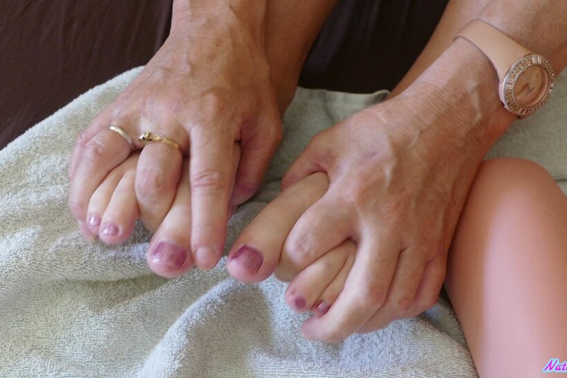 Natalie K strokes her feet first, then finishes with a footjob, photo 2 of 15
