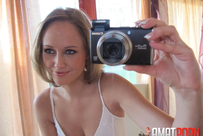 Image 1/15: Mirror selfie shows a petite teen baring her big tits