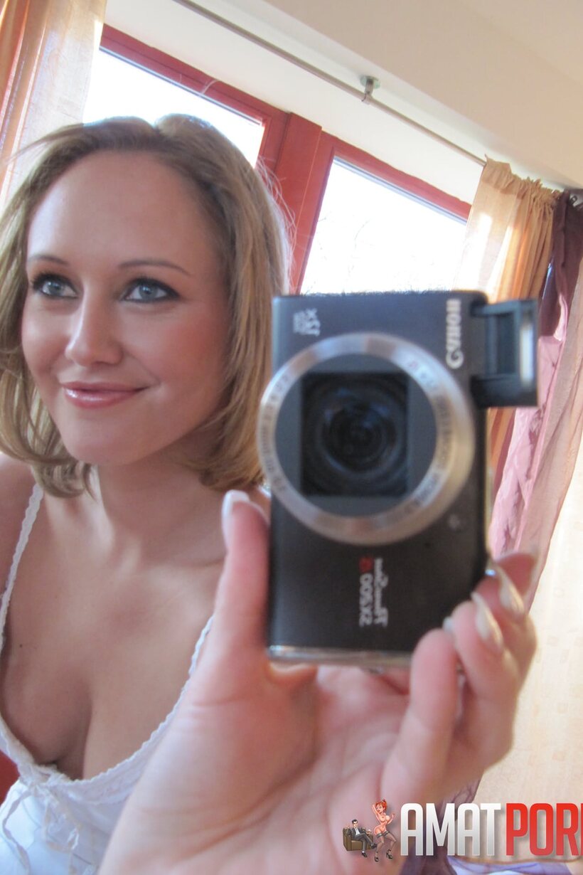 Mirror selfie shows a petite teen baring her big tits, photo 2 of 15