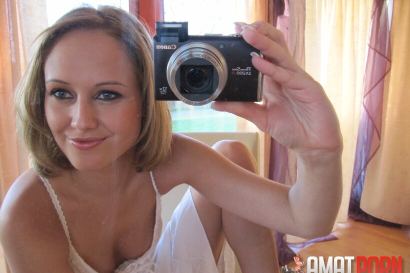 Photo 5 — Mirror selfie shows a petite teen baring her big tits