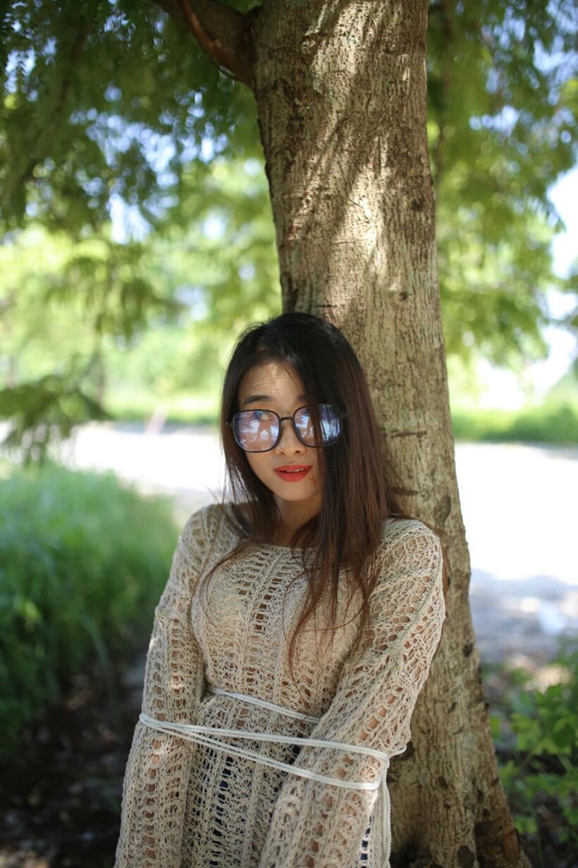 Posing in a cute outfit outdoors, Elena shows off her glasses and Asian charm (shot 3)