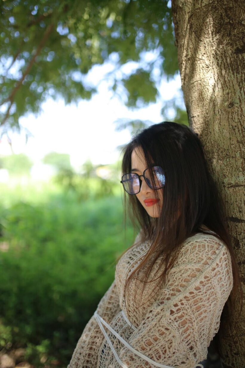 Posing in a cute outfit outdoors, Elena shows off her glasses and Asian charm (shot 8)