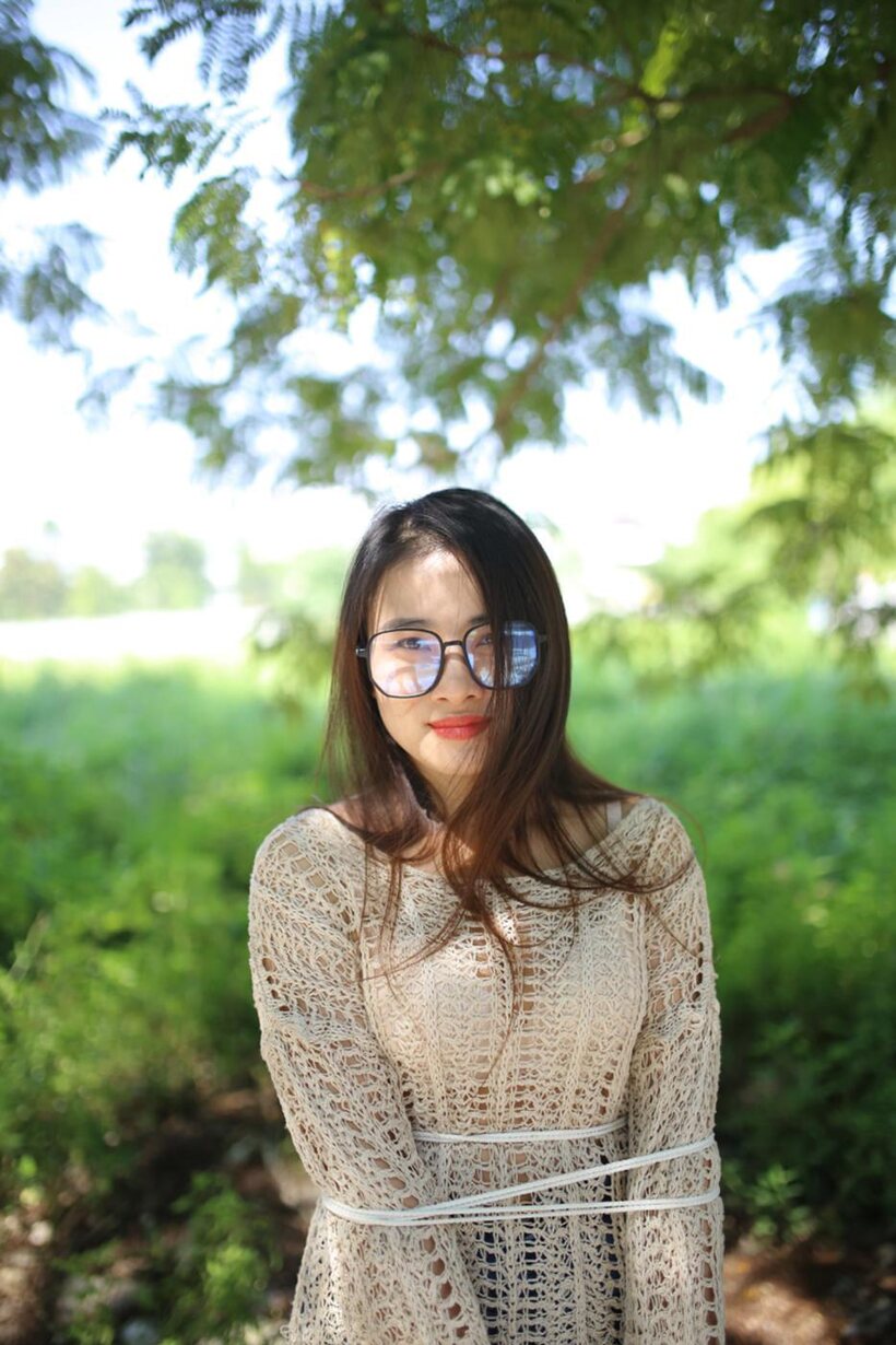 Image 13/21: Posing in a cute outfit outdoors, Elena shows off her glasses and Asian charm