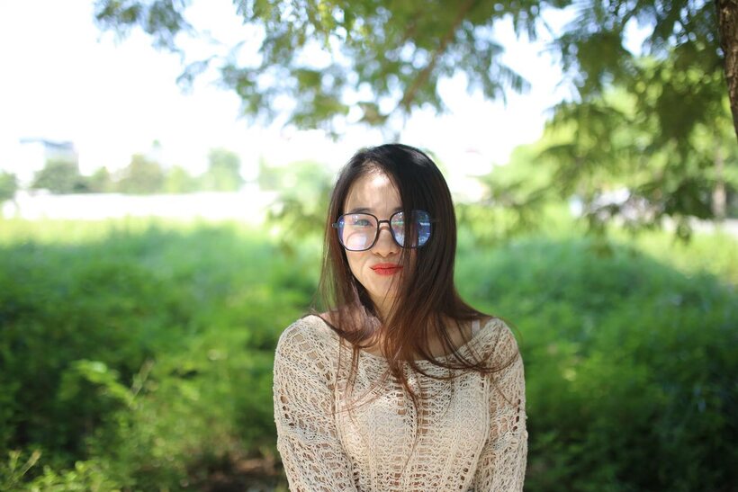 Posing in a cute outfit outdoors, Elena shows off her glasses and Asian charm (shot 14)