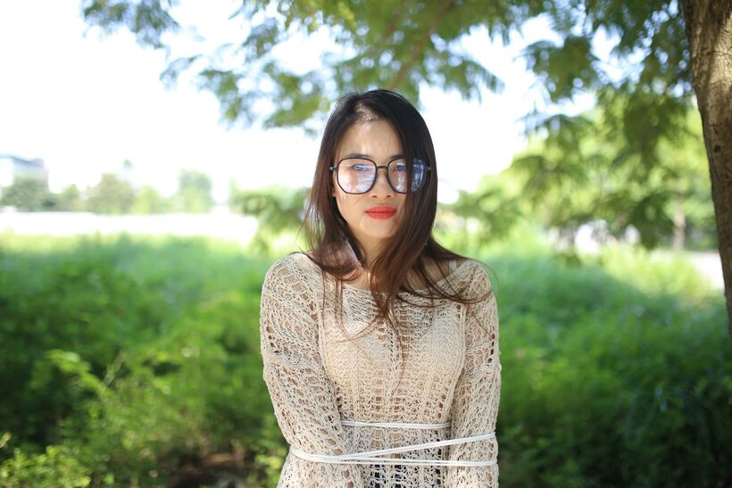 Image 19/21: Posing in a cute outfit outdoors, Elena shows off her glasses and Asian charm