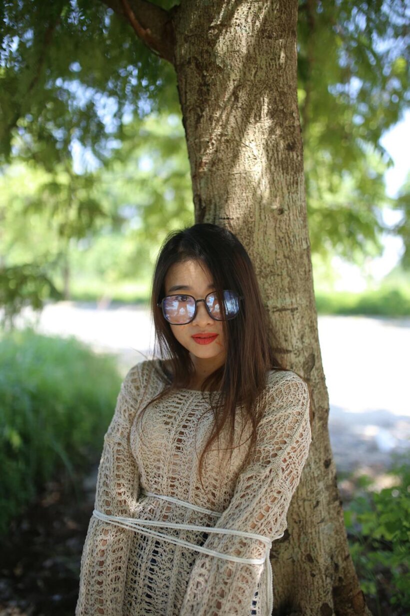 Photo 21 — Posing in a cute outfit outdoors, Elena shows off her glasses and Asian charm