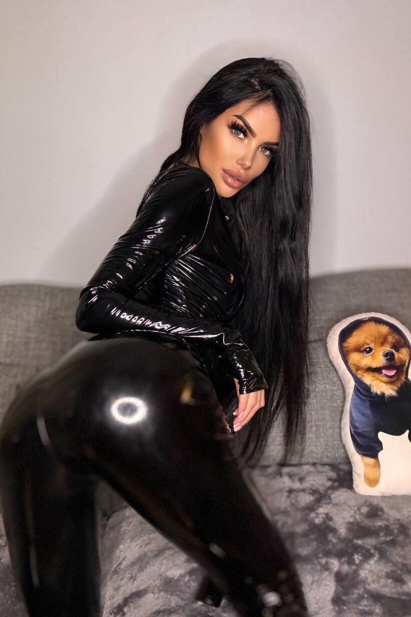 Image 9/10: Sophia 69 slips out of her latex suit and frees her tits