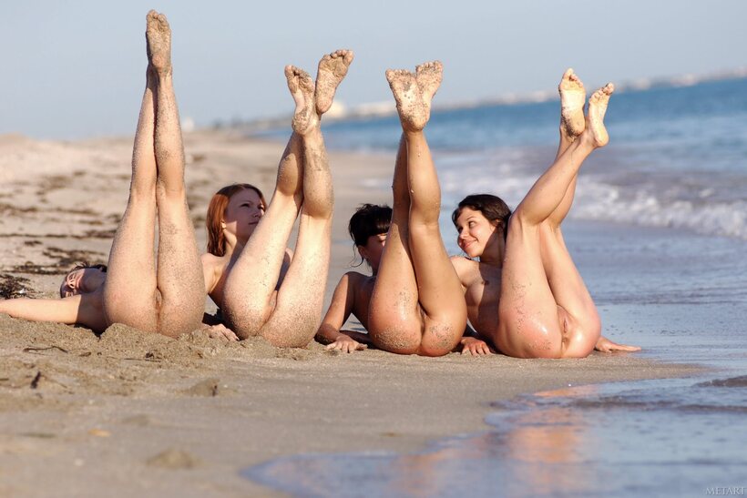 Rita B and teens roll in the sand before heading into the surf (shot 12)