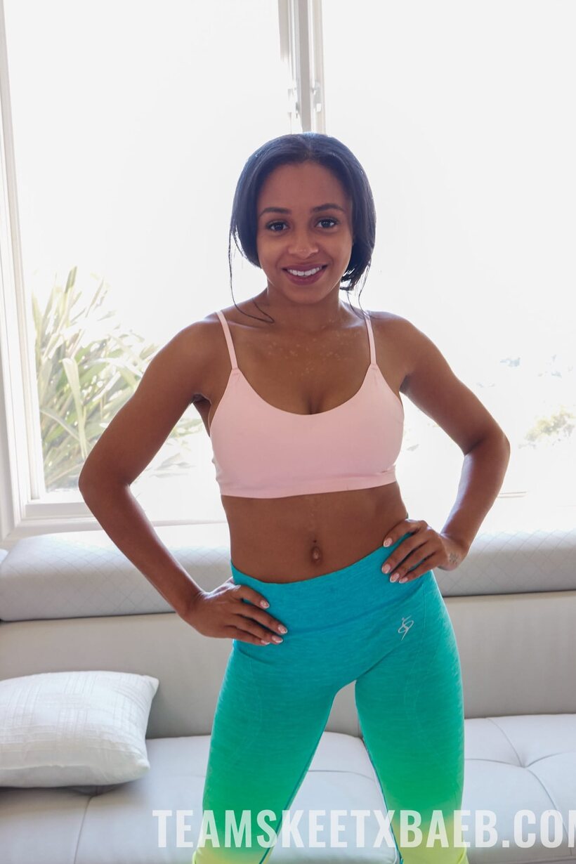Ebony Anya Ivy exposes her natural tits while undressing (shot 1)