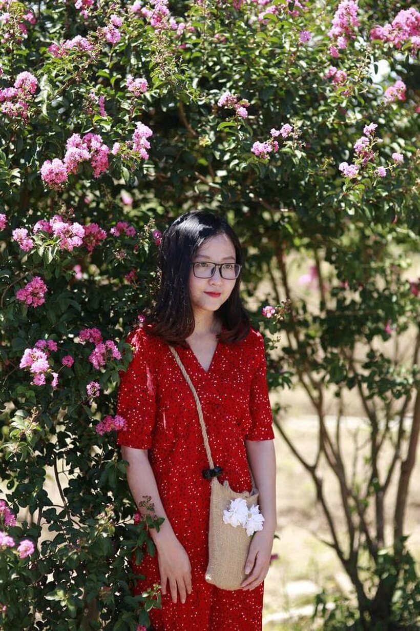 Image 7/21: Glasses on, an Asian babe poses outdoors in a red dress