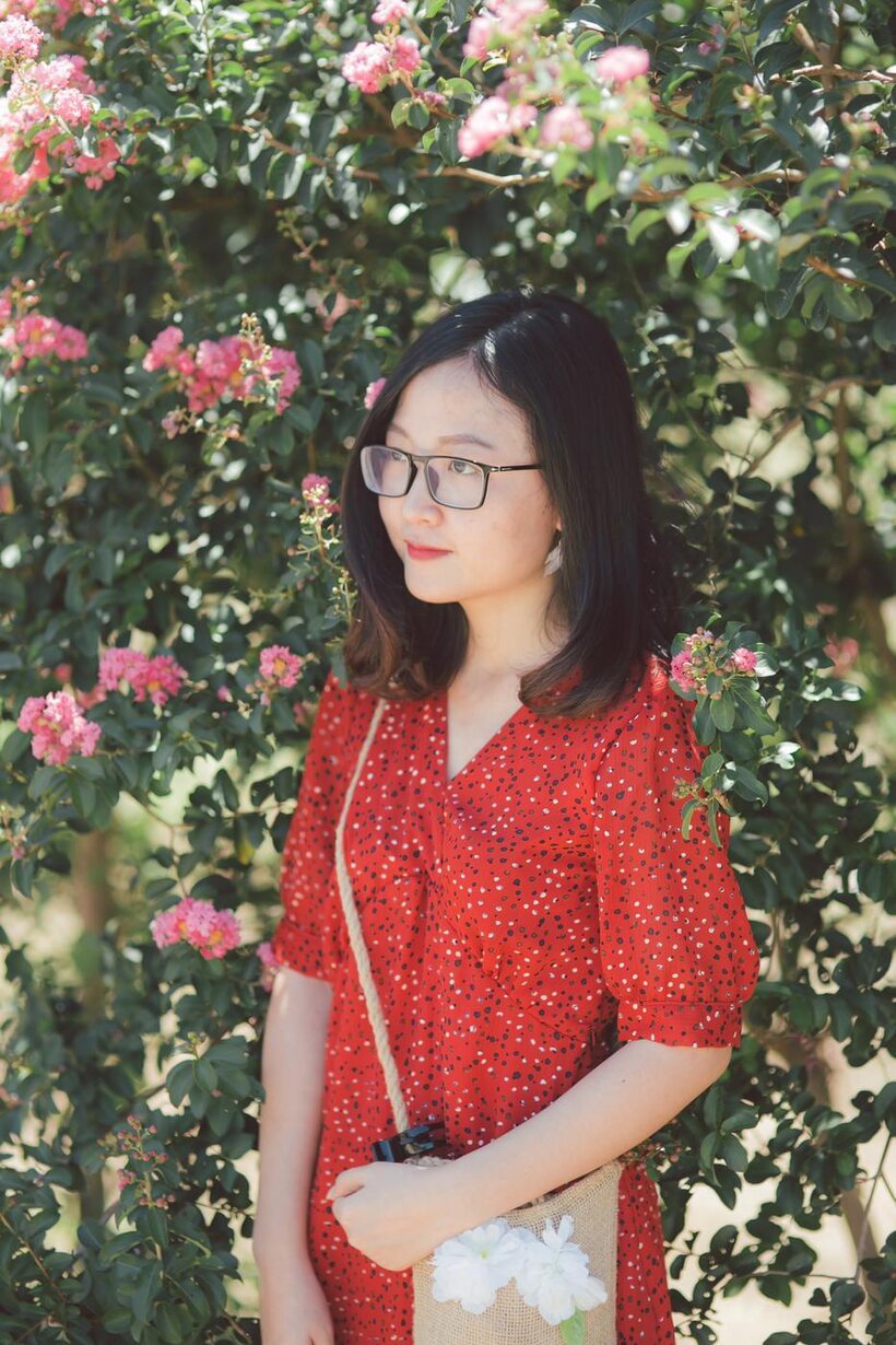 Amateur nude photo 8 — Glasses on, an Asian babe poses outdoors in a red dress