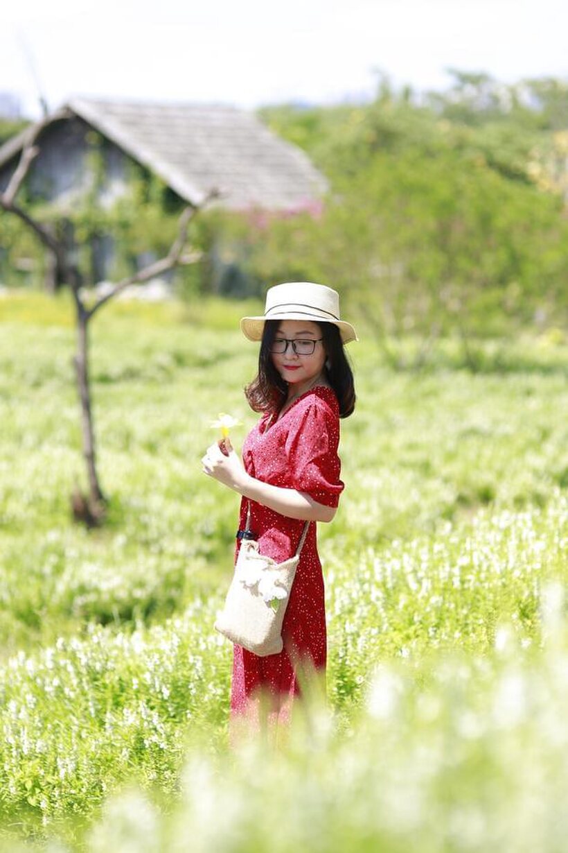Photo 9 — Glasses on, an Asian babe poses outdoors in a red dress