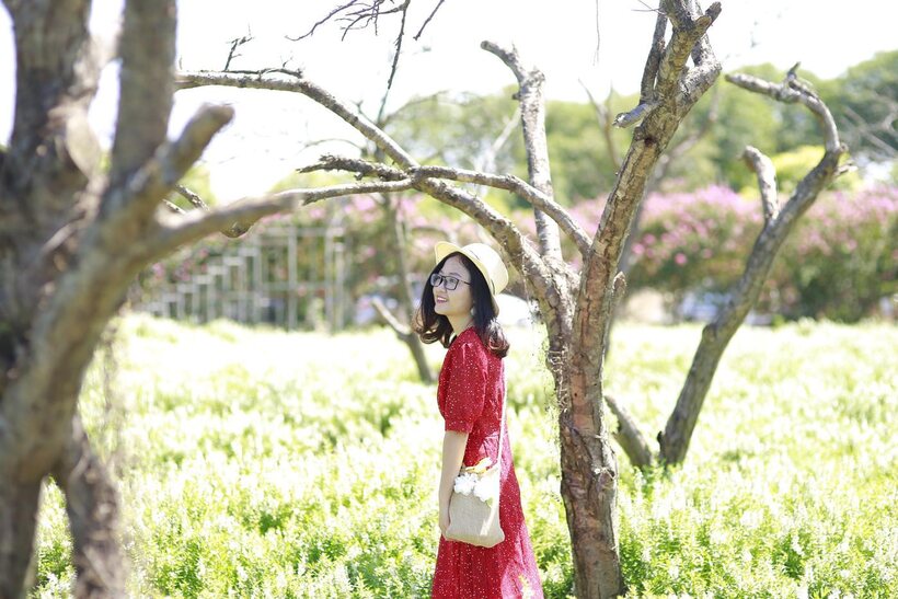 Photo 16 — Glasses on, an Asian babe poses outdoors in a red dress