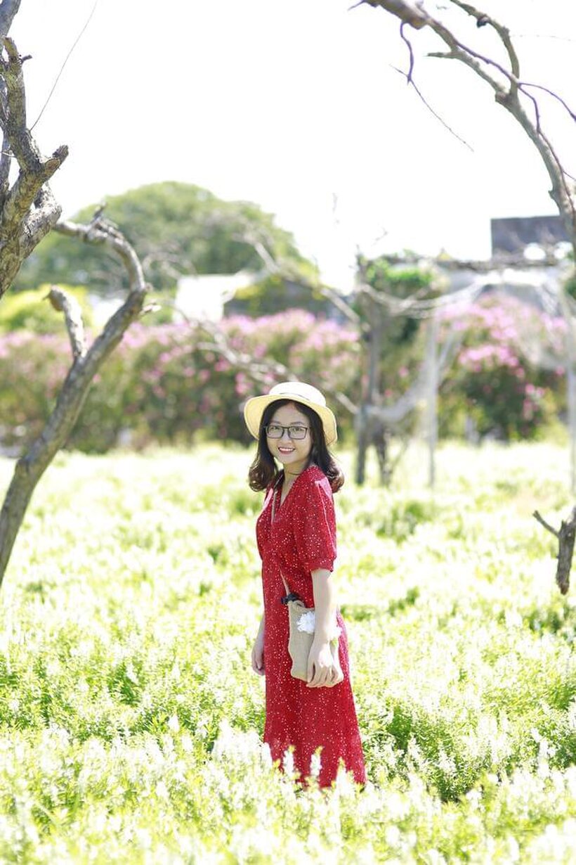 Image 18/21: Glasses on, an Asian babe poses outdoors in a red dress