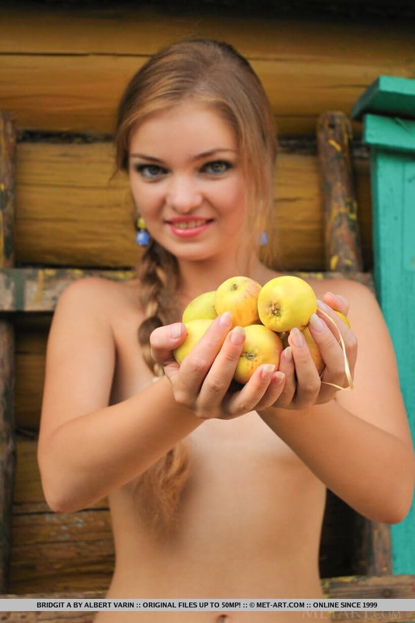 Photo 8 — Bridgit A spreads her legs to show off her wet pussy on the farm