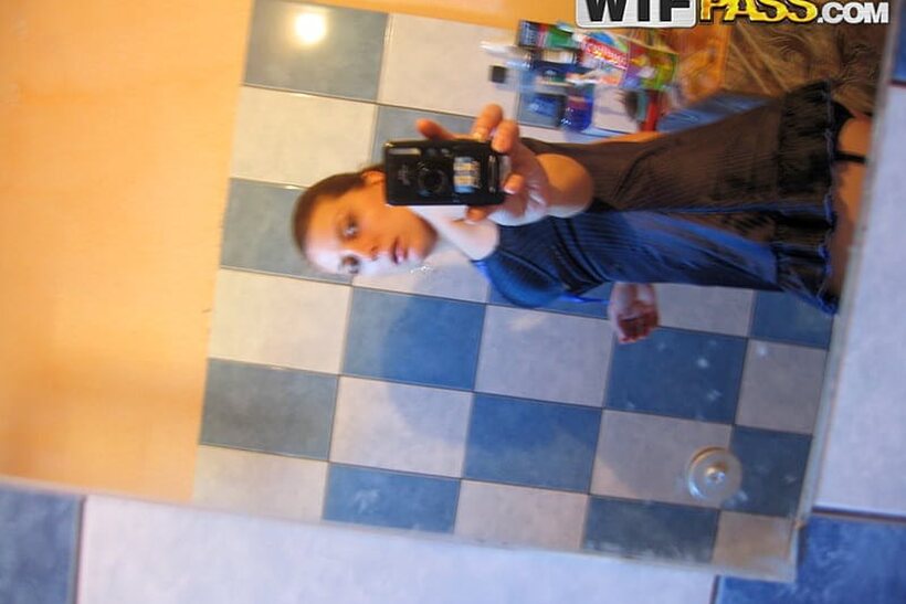 Photo 14 — Amateur girl flaunts her big tits and ass while taking selfies