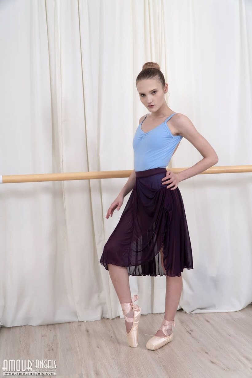 Image 1/20: Olivia slips out of her dance outfit and teases the bar with her ass