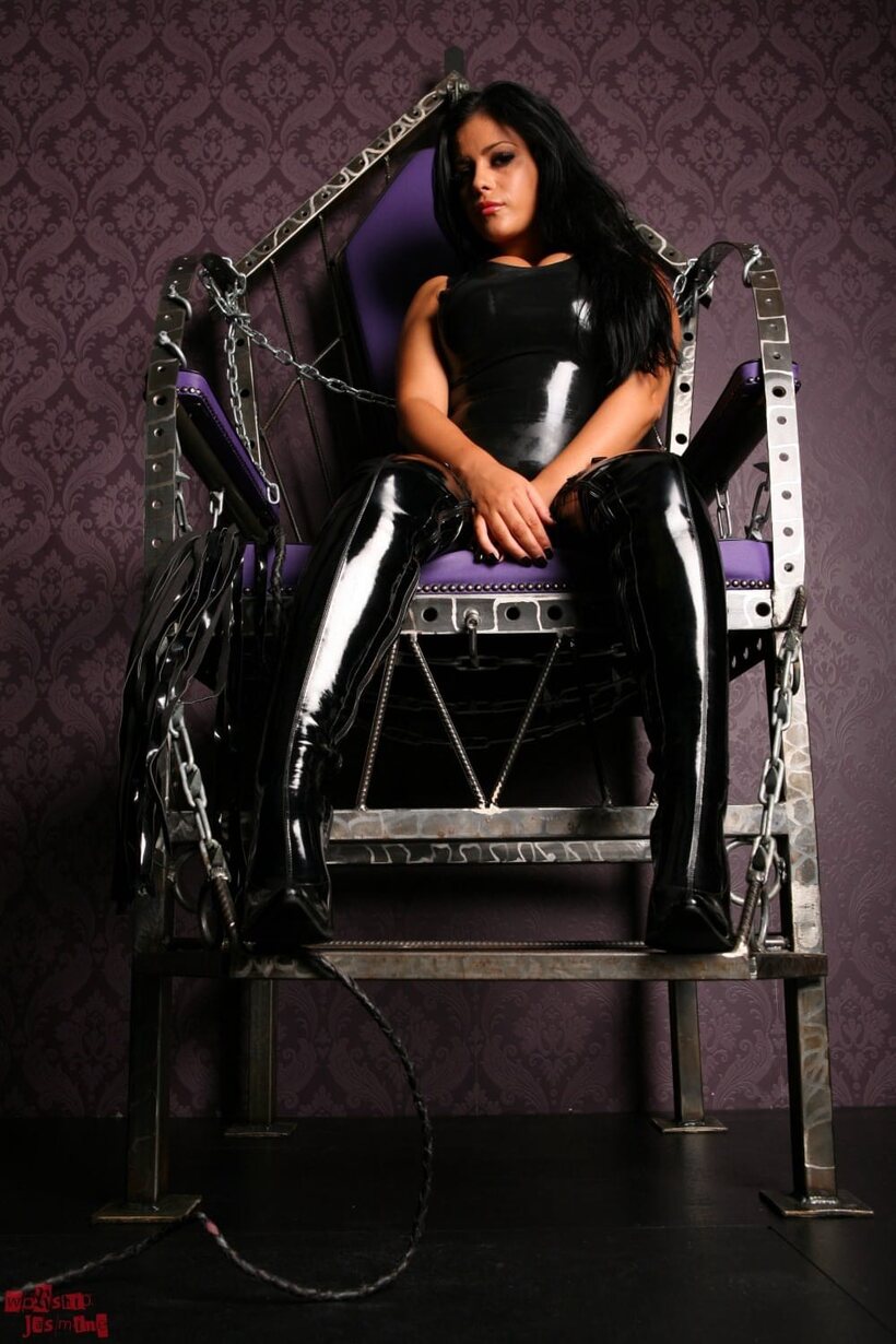 Photo 2 — Keira Jones steps down from her throne to leash a male slave in latex