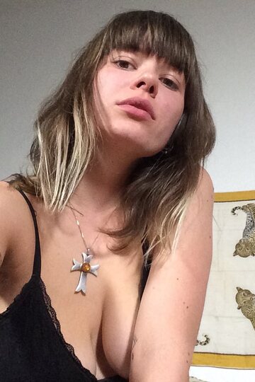 Tattooed girl gets naked in bed