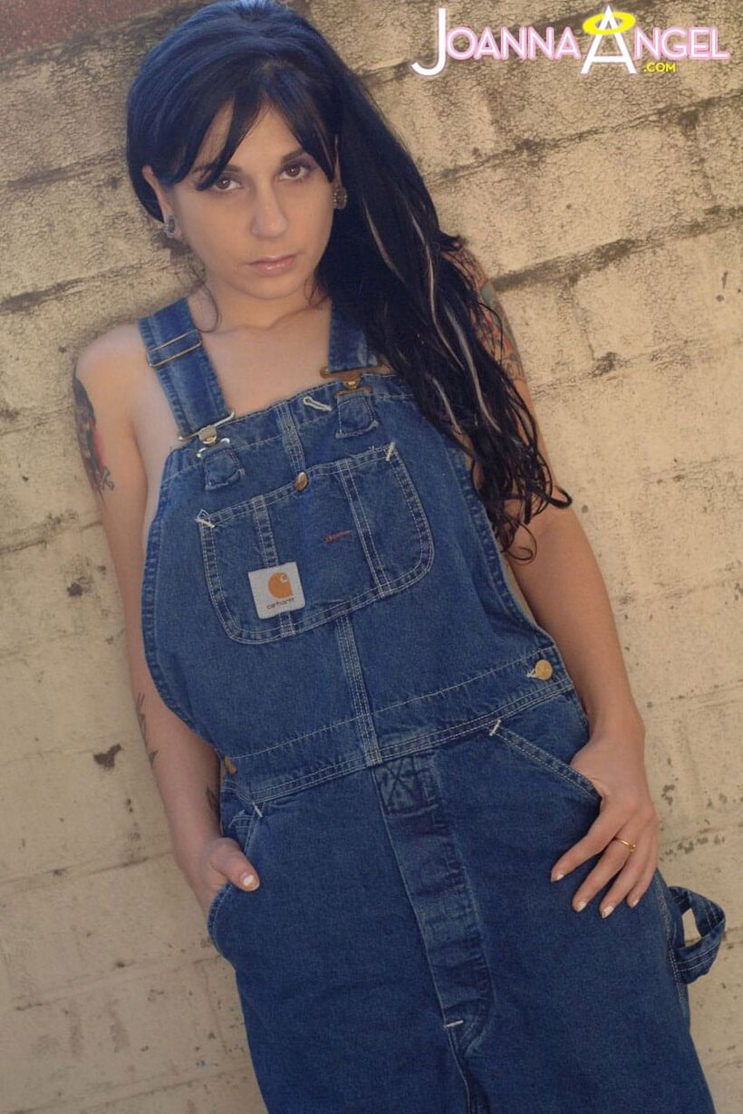 Joanna Angel lets her boobs spill from overalls before stripping (shot 3)