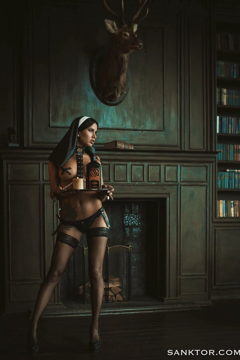 Image 8/21: Smoking in a nun outfit, Lina Melton shows off her curves