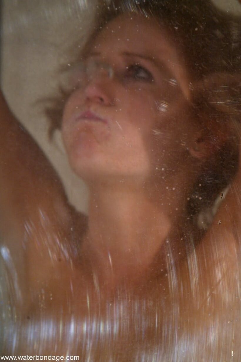 Jessica Sexin is held underwater inside a glass bondage box (shot 19)