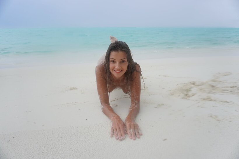 Photo 2 — Melena Tara goes nude on the beach, letting sand coat her body