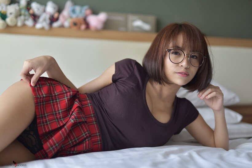 Photo 3 — In a miniskirt and panties, pretty Asian teen shows off her ass