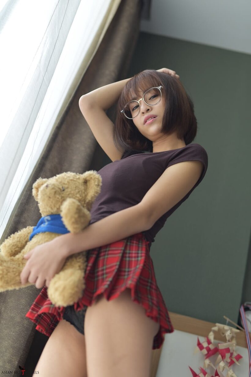 Image 6/20: In a miniskirt and panties, pretty Asian teen shows off her ass
