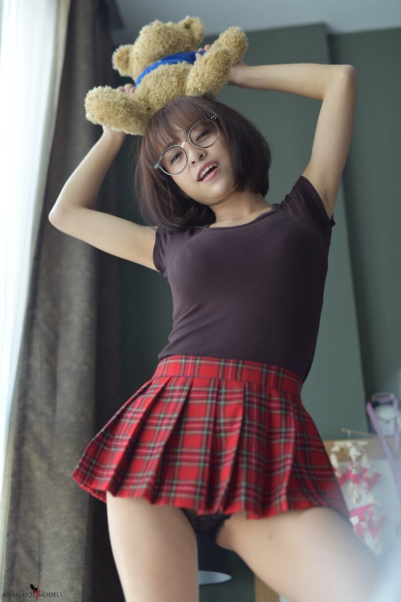 Photo 9 — In a miniskirt and panties, pretty Asian teen shows off her ass
