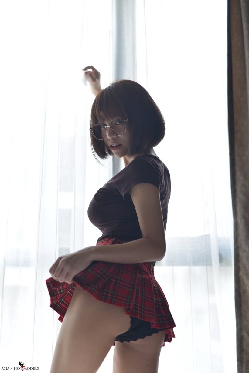 In a miniskirt and panties, pretty Asian teen shows off her ass (shot 17)