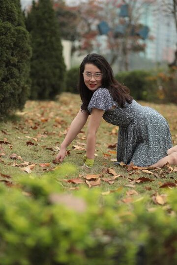 Elena poses in a summer dress, showing off her curvy Asian figure