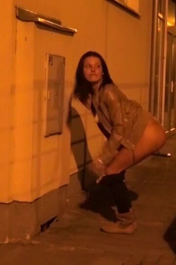 Brunette girl pissing in public