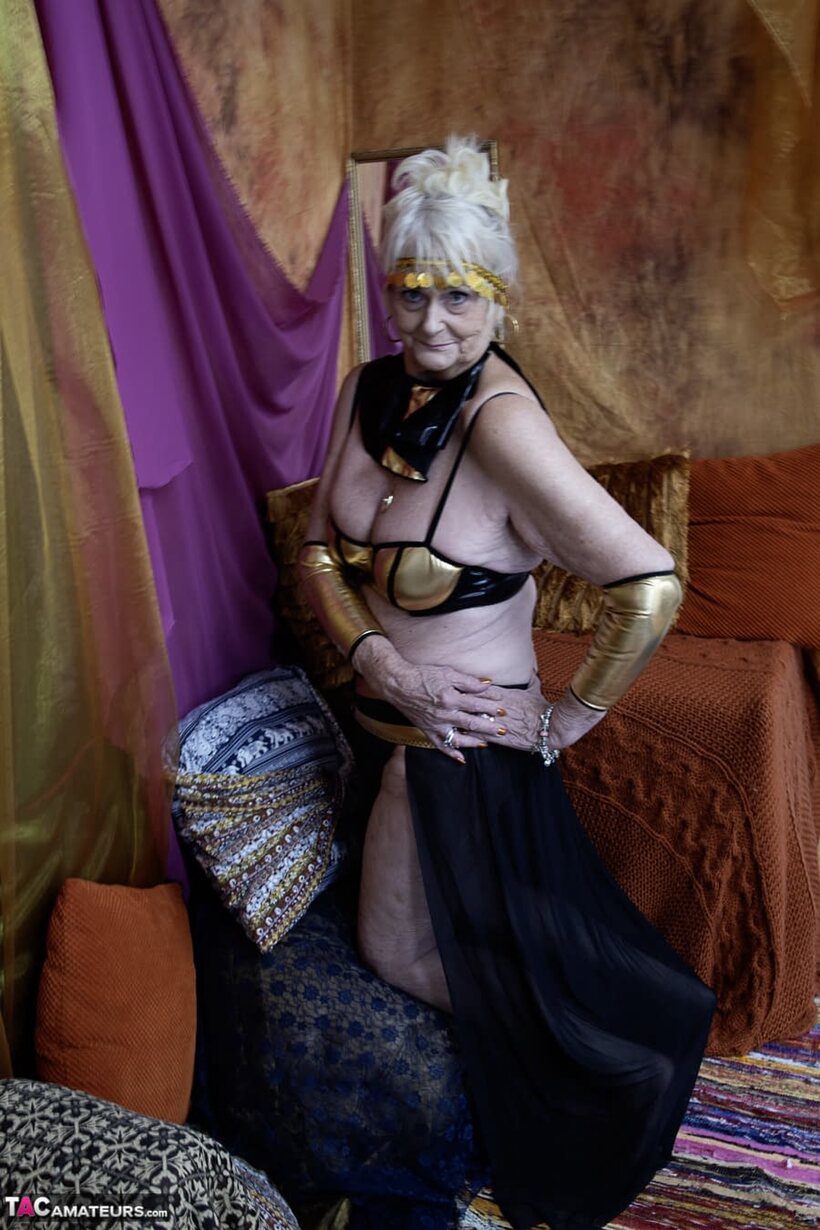 Photo 8 — Solo modelling shows an older blonde woman’s saggy tits and curves