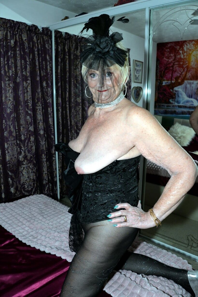 Blonde granny slips out of black lingerie, exposing her big natural tits, photo 11 of 16
