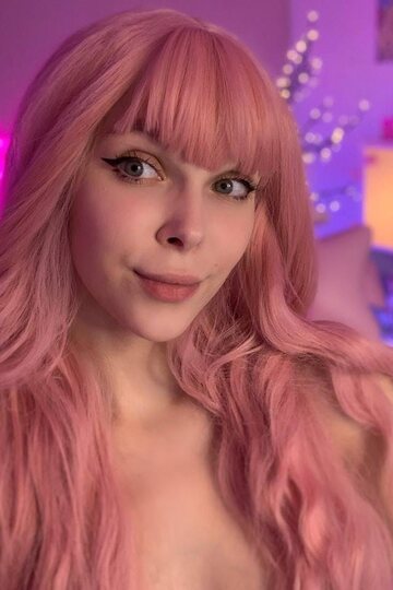 Headphones on, pink-haired teen shows off her natural tits