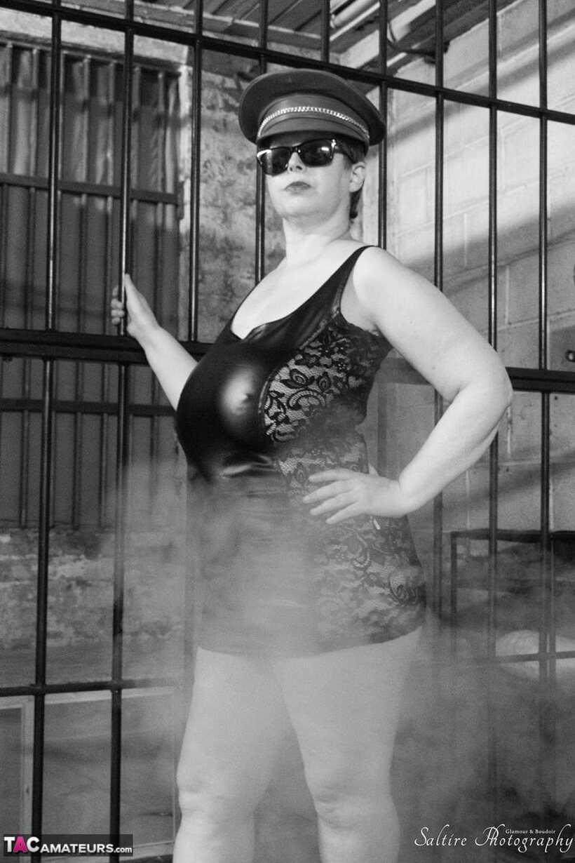 Posh Sophia poses in fetish outfits inside and outside a jail cell (shot 4)