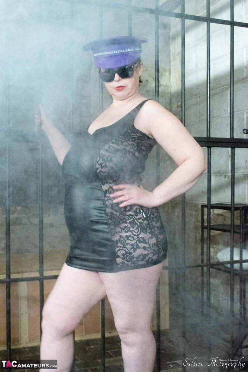 Posh Sophia poses in fetish outfits inside and outside a jail cell (shot 6)
